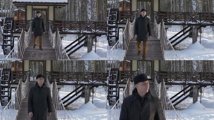 帅哥走在冬季城市公园的装饰桥上慢动作