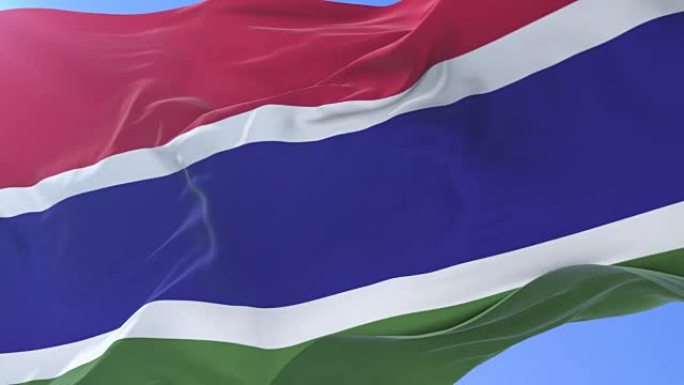 冈比亚国旗在蓝天下缓慢地挥舞着，循环