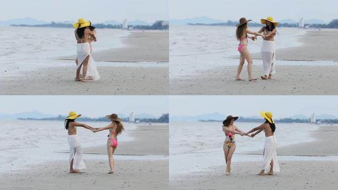 穿着比基尼的女人在夏天和朋友在海滩散步。