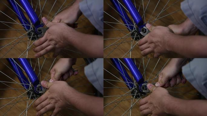 这个人把车轮从自行车上拿下来。用扳手拧下螺母。