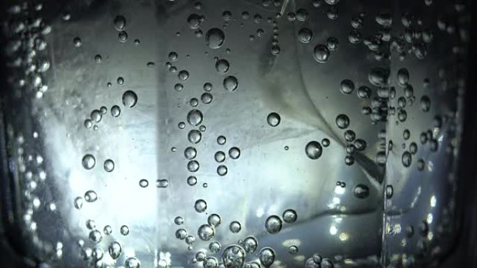 Bubbles on glass with sparkling water