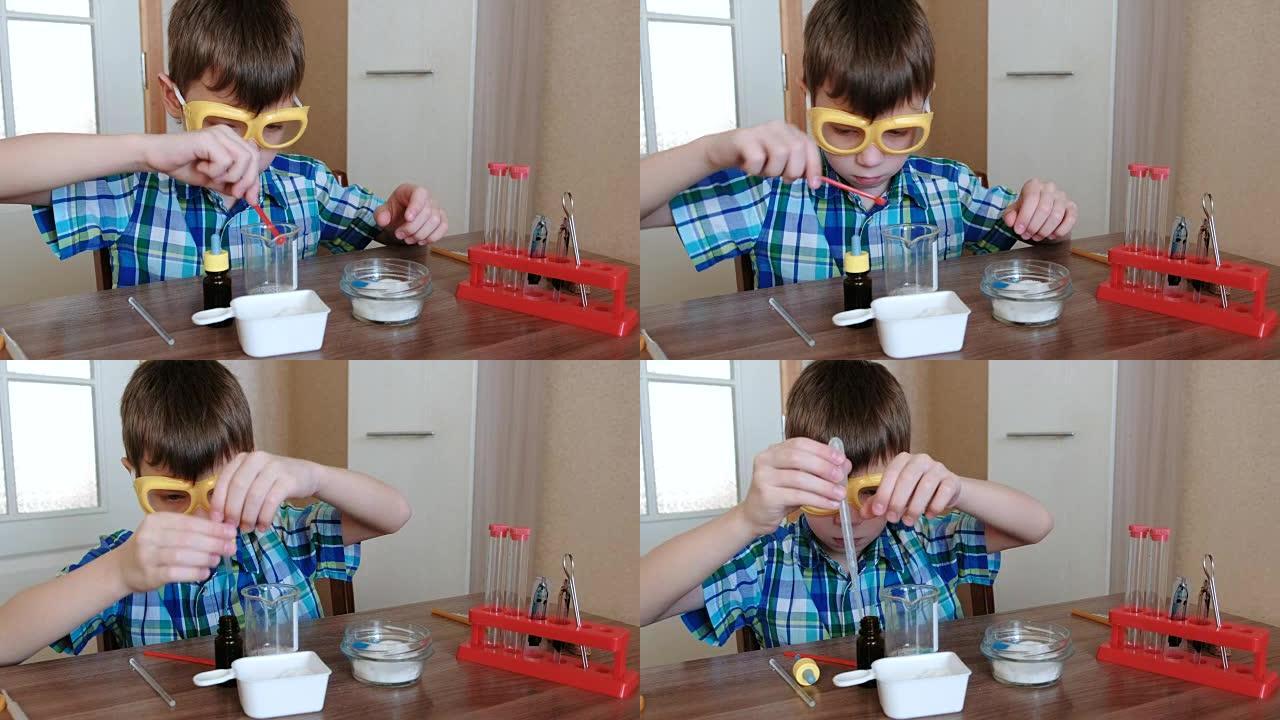 在家进行化学实验。男孩在烧杯中混合物质和蓝色液体。