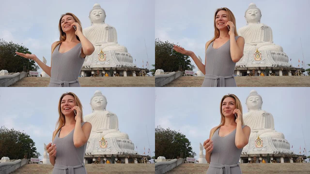 慢动作旅游女士在泰国佛像附近的智能手机上聊天