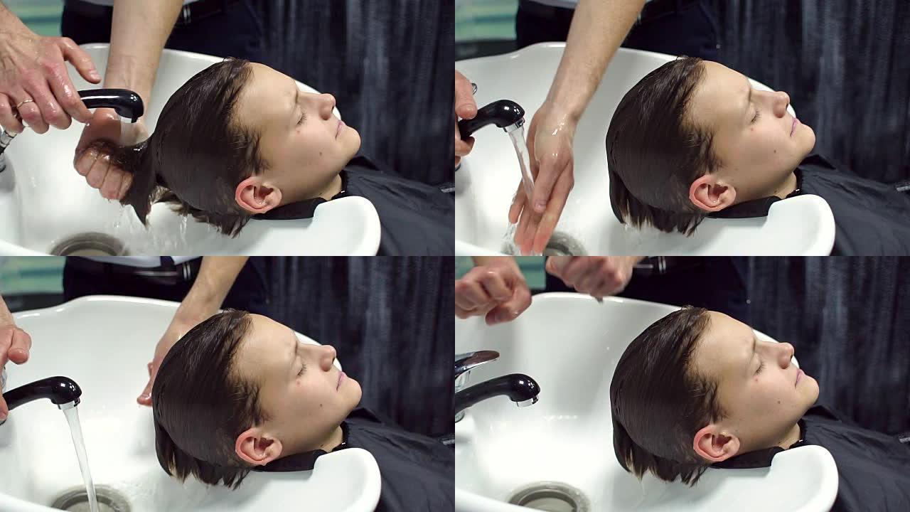 理发师在美发沙龙洗青少年的头发