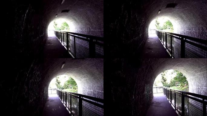 POV慢动作视频的人走过黑暗的隧道