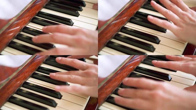 女性手指在复古钢琴键盘上弹奏琴键。浅景深。专注于钢琴按键