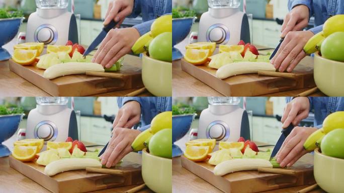女人的手在厨房的砧板上切各种水果