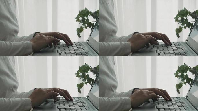 女性设计师hand的特写镜头正在为设计过程制作电脑笔记本电脑