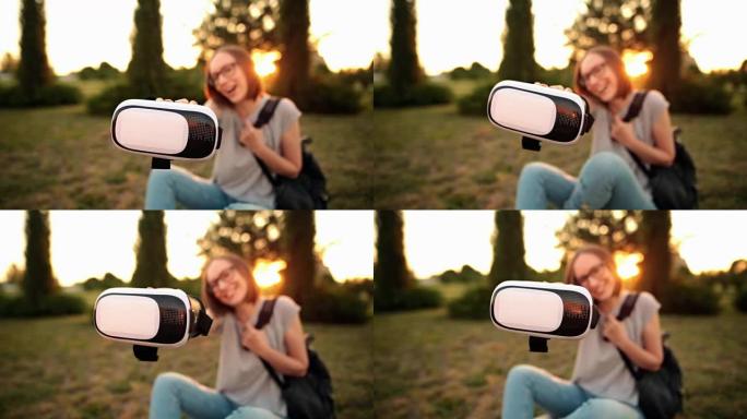 选择性关注年轻微笑女孩手中的虚拟现实眼镜