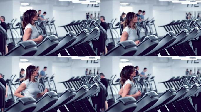 Adult woman runs on treadmill at the fitness centr