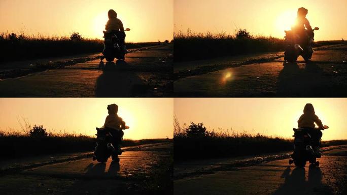 小男孩骑着电动摩托车玩具