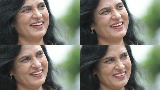 成熟快乐美丽的印度女人在户外街头思考的特写镜头