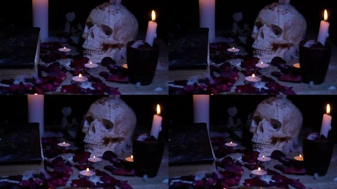 魔法书，带蜡烛和玫瑰花瓣的头骨