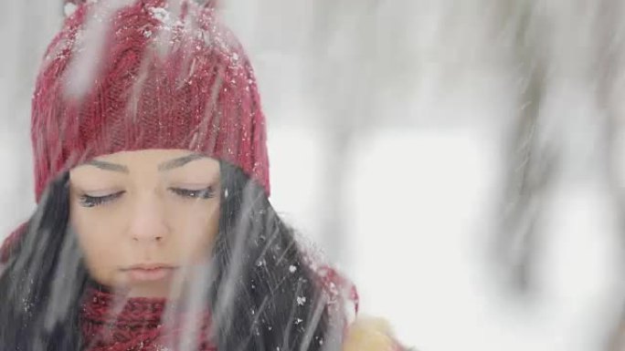 Don't moving frozen woman in hat under falling sno
