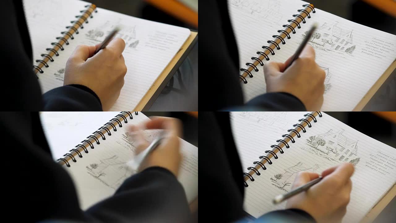 手握铅笔在笔记本上写字或画画。成人用软尖铅笔着色。女手绘图铅笔在笔记本特写