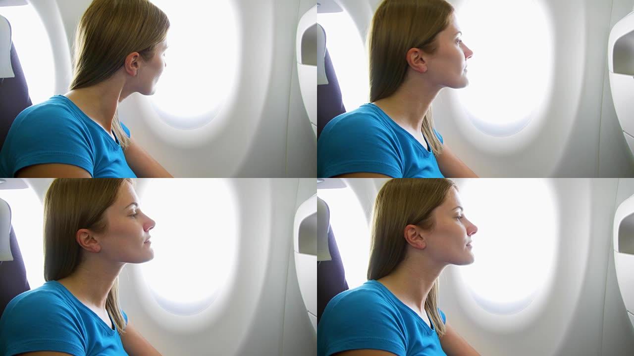白天坐飞机的女人。因时差而疲倦的女性在湍流期间在窗户附近放松