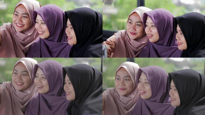 美丽的东南亚穆斯林妇女与头巾做视频通话编辑和原始
