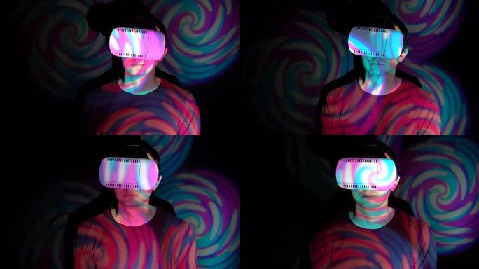 在聚光灯下使用VR头盔的人的肖像