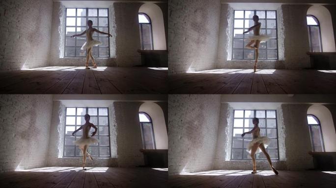芭蕾舞女演员白天在大窗户前表演fouette