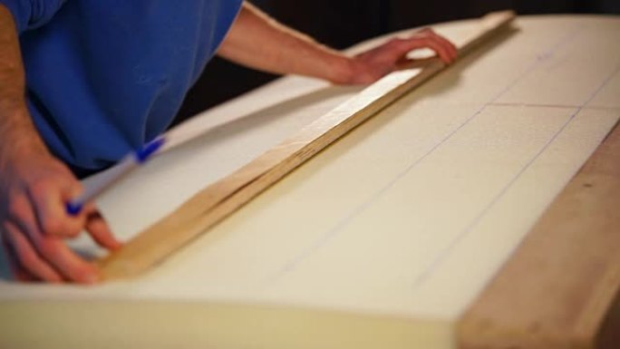 employee's hands, who draws a line using a felt-ti