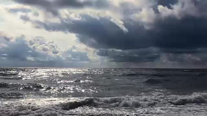 海上沙滩上的暴风雨，阴云密布，风追逐海浪和云层。