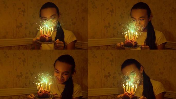 12岁的白人女孩在黑暗中拿着蜡烛的小生日蛋糕吹灭了。蛋糕上方闪闪发光的魔法面粉动画。