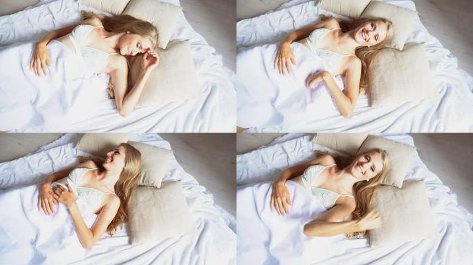 美丽的女孩睡在白色的床上，看到早晨的梦想