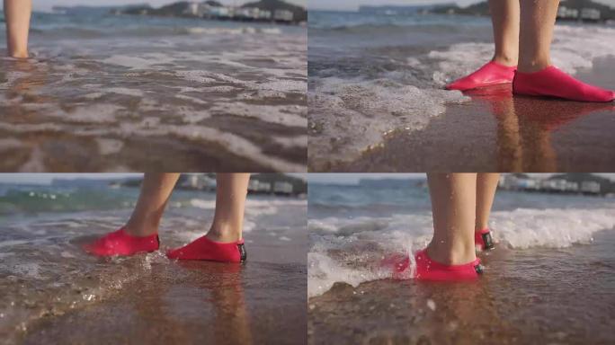穿着胶鞋在沙滩上行走的女孩
