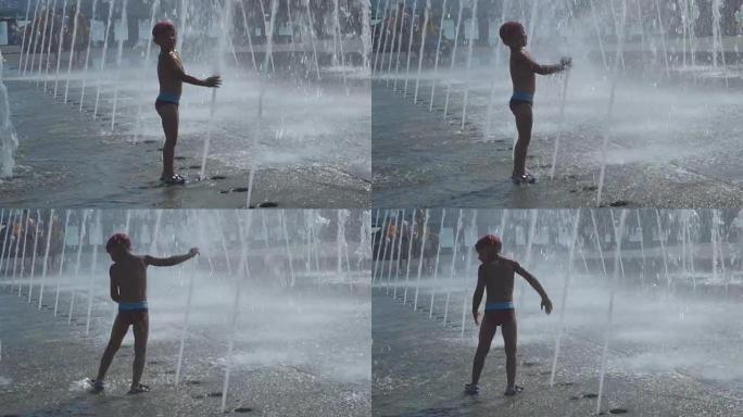 这个男孩正在喷泉里玩耍