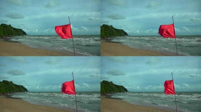 夏天，海水在岩石海滩上挥水。关闭海浪溅到海洋海滩上，红旗，危险警告