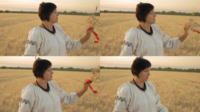 慢动作，特写镜头，穿着国家衬衫的女人站在球场上，看着用红丝带连接的手中的小麦尖刺