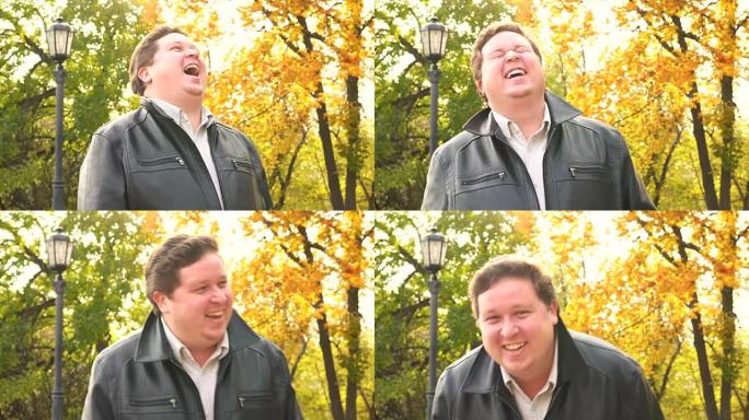 快乐的胖子在公园里大笑。肖像
