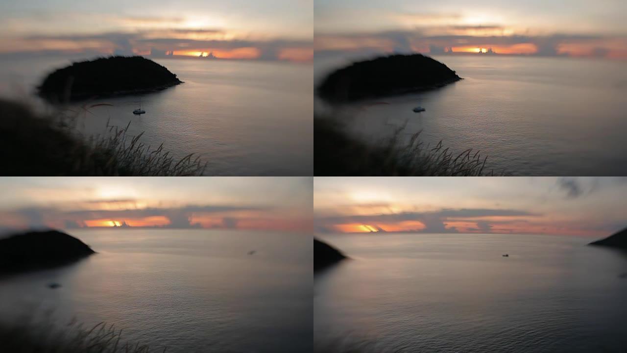 帆船在海浪上滑行。日落背景上的云景。卡塔海滩视点。镜头宝贝甜美的35毫米。泰国普吉岛