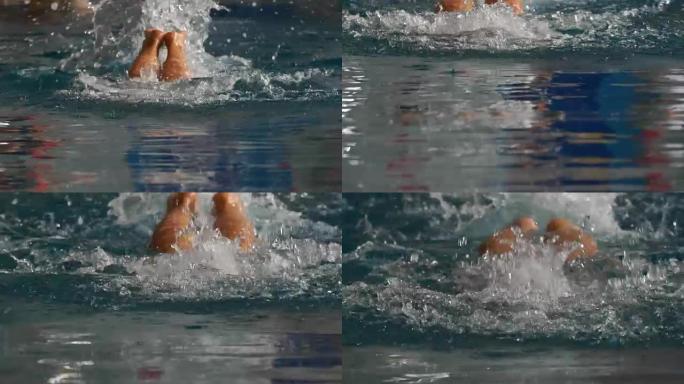 慢动作: 女运动员以蝶式游泳。一名女子游泳运动员参加游泳比赛。