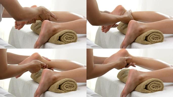 专业治疗师为水疗中心的女性提供传统的泰国腿部和足部按摩