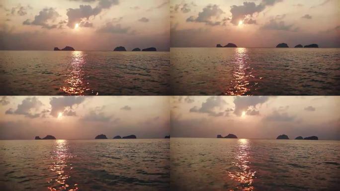 美丽的日落在海上，从快艇上看到的小岛。1920 x1080