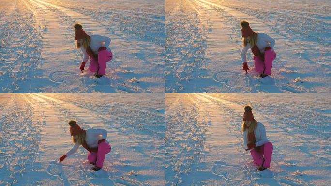 女人在冬天的日落在雪上画与手心4k