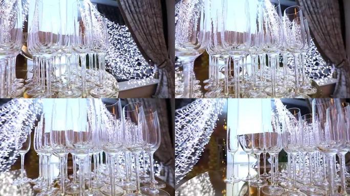 自助餐桌上的玻璃杯，一瓶香槟，餐厅设计，室内，室内，相机沿着桌子平稳移动，桌上一排排酒杯，浅景深