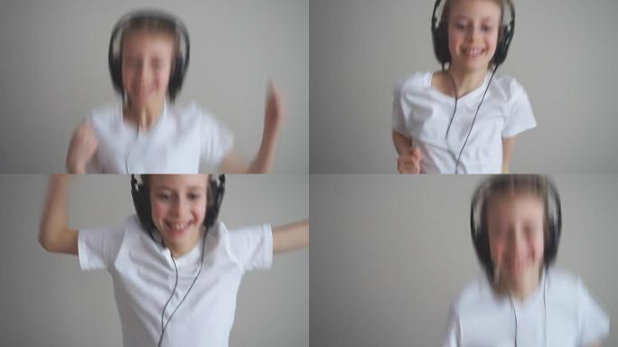 快乐的小女孩戴着耳机跳舞。慢动作。