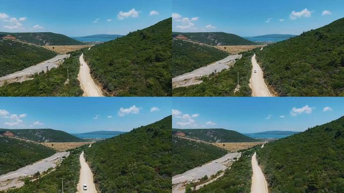 彩色森林和道路的鸟瞰图。俯视森林。森林中途中的鸟瞰图4k