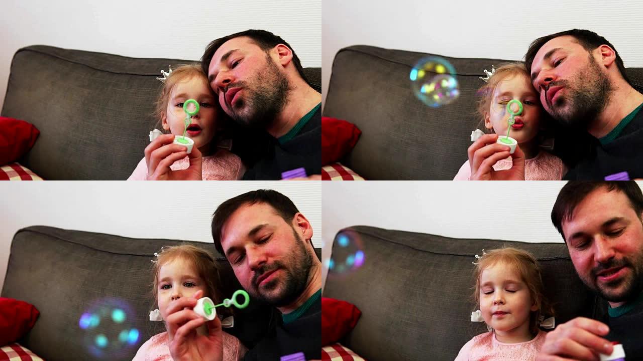 一个父亲和他的孩子一起吹肥皂泡。一个小女孩慢动作地打睫毛。