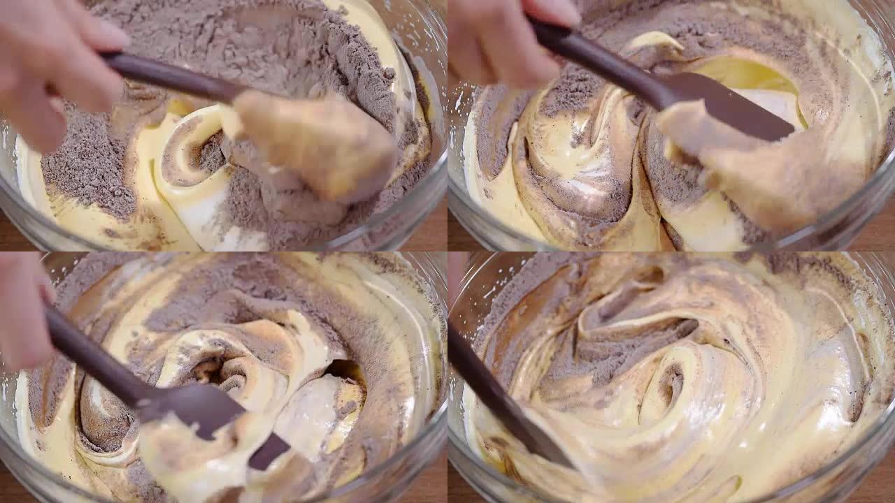 一碗巧克力面糊被搅拌着。制作巧克力面糊的过程。