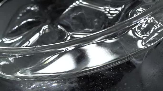 Glass of water with ice in rotation