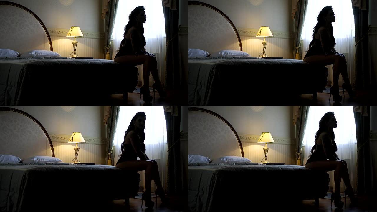 热情美丽的模特躺在酒店的床上，摆姿势拍照