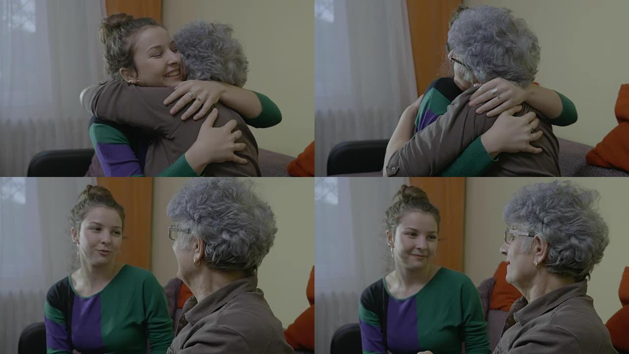 年轻的女学生在家探望她后，拥抱和亲吻她的祖母老师再见