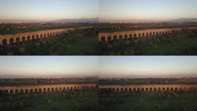 从上面看视频。日落时分，罗马渡槽的古老遗迹鸟瞰图被绿色公园包围，人们在那里跑步或度过周末。Parco