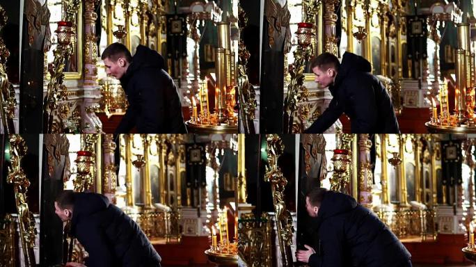 年轻人在东正教教堂鞠躬亲吻十字架