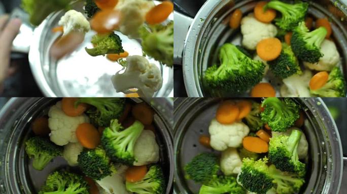 胡萝卜西兰花和花椰菜溅入水慢动作视频