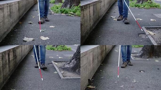 用拐杖走路的盲人的腿特写。独立，不易行