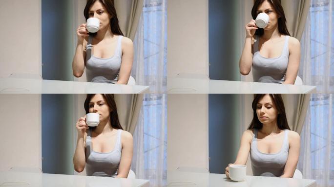 年轻女子喝热咖啡，坐在家里